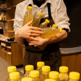 bottiglie brodo di carne in mano